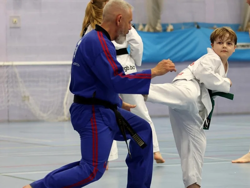 ATI Martial Arts founder Rodney Lockyer guiding a student during a Taekwondo class.